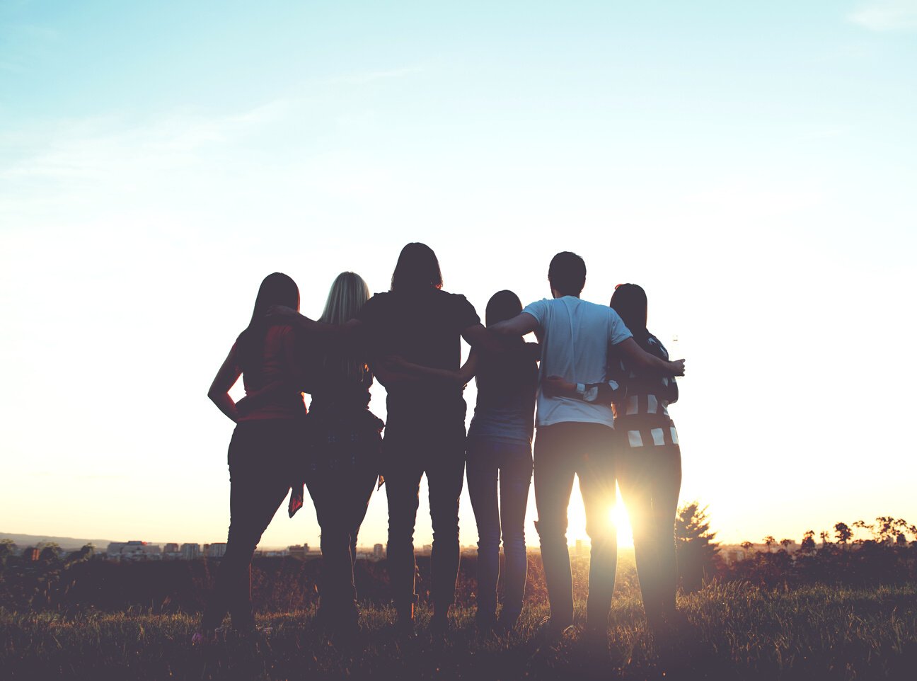 Group of people having fun outdoors; sunset